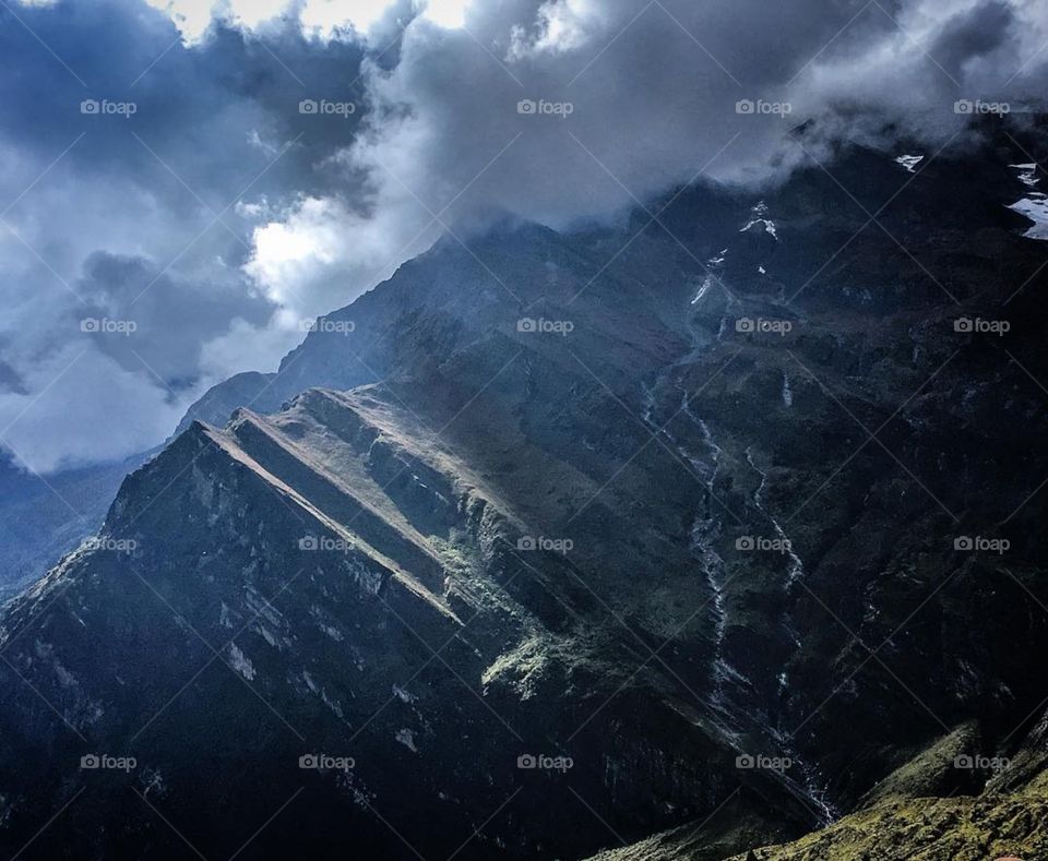 The clouds start rolling in from the bottom of the valley. I love how the landscape became dulled by the clouds. Photo taken on the Dhaulagiri Circuit Trek in Nepal.