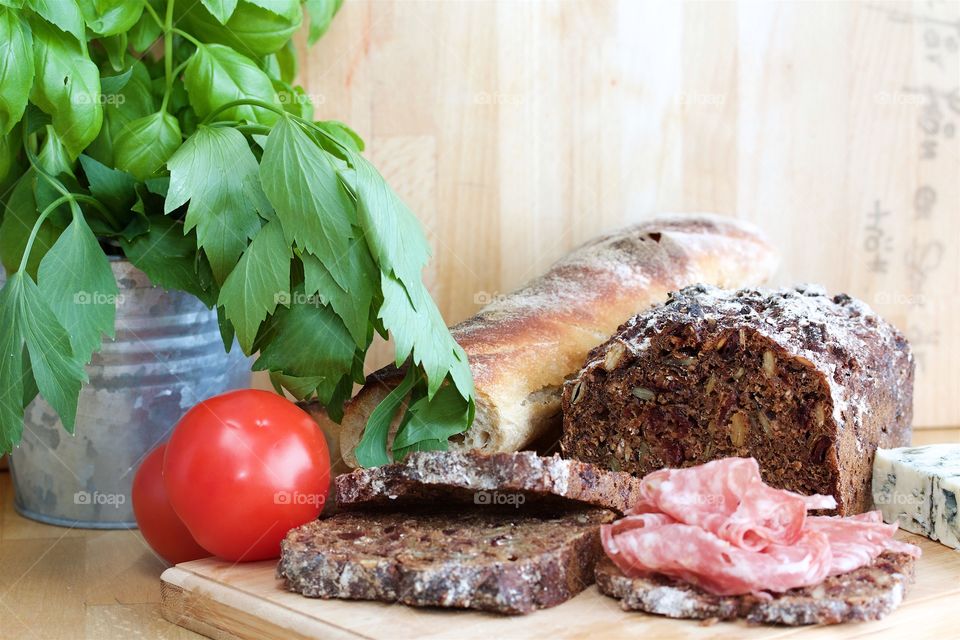 Bread with salami on chopping board