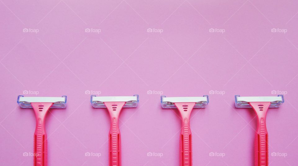 Pink razors on pink background