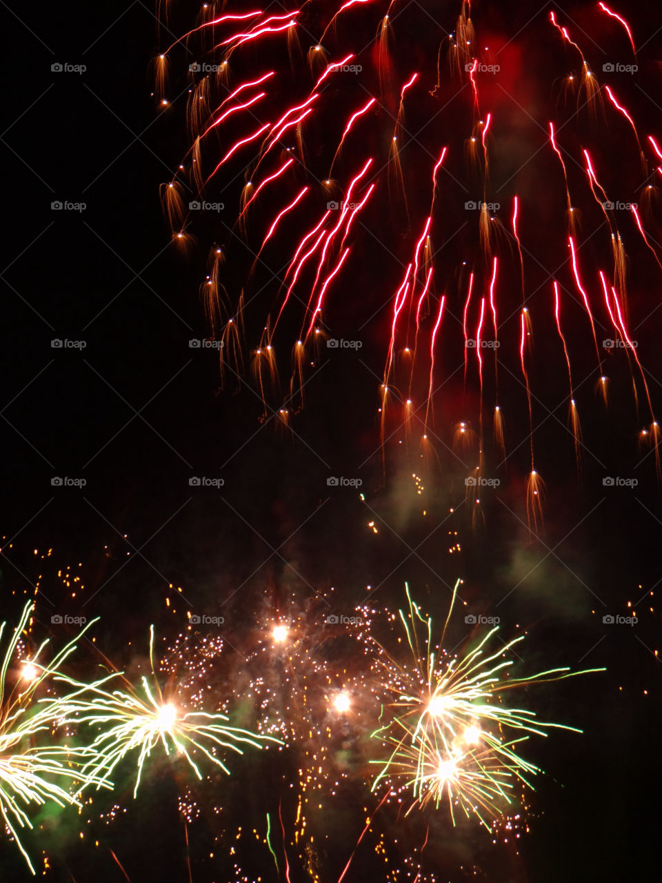 Illuminated firework display at night