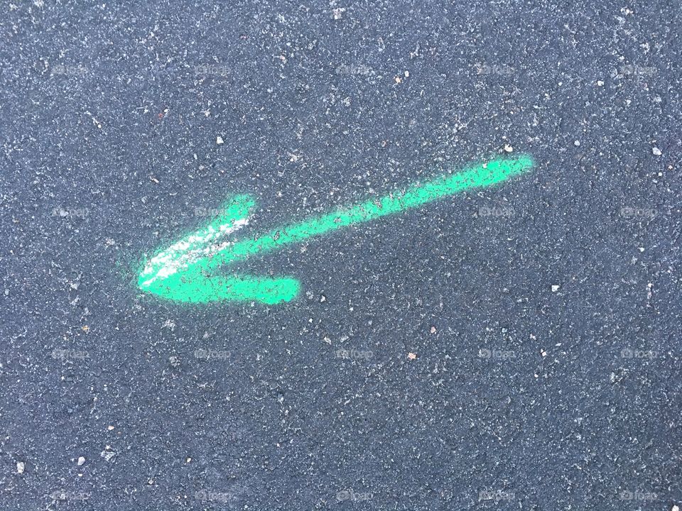 Green marking arrow possibly for gas on the street