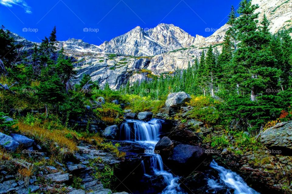 Blue waterfall  green meadows