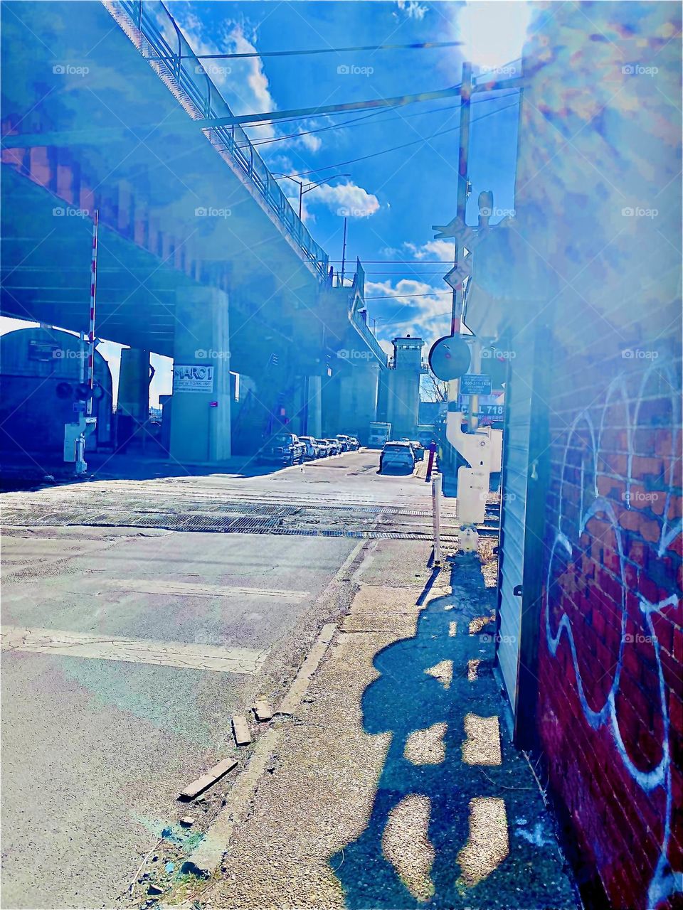 Amazing lens flares and auras form from the sunlight refracting off various building structures by the parking lot beneath the Pulaski Bridge in LIC, Queens, NY. We walk through here regularly and cross the train tracks. 2022. Hypnotic Productions