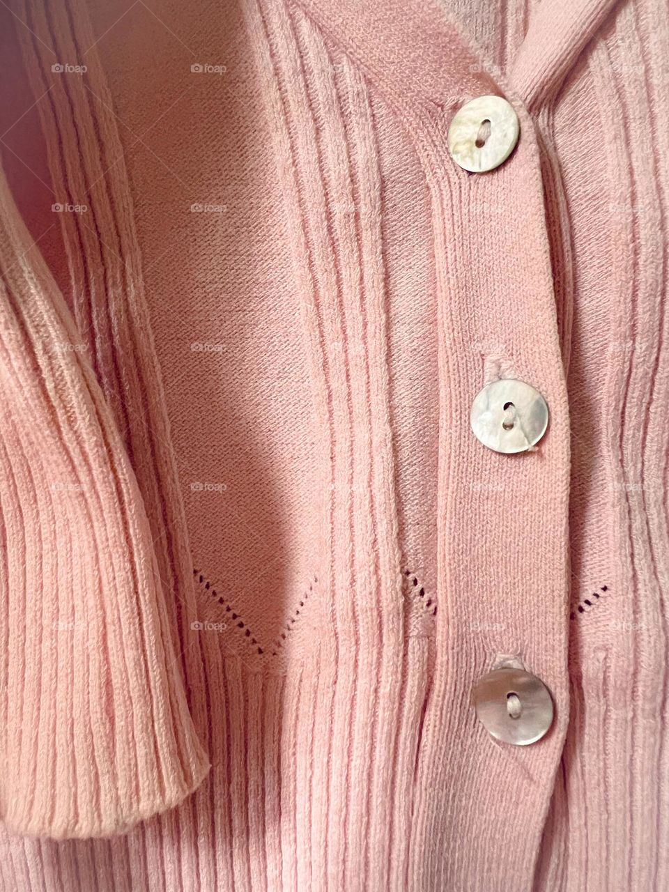 Buttons of pink sweater 