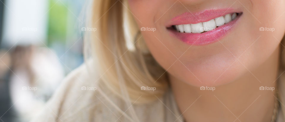 pretty woman smiling with beautiful white teeth and rose lipstick