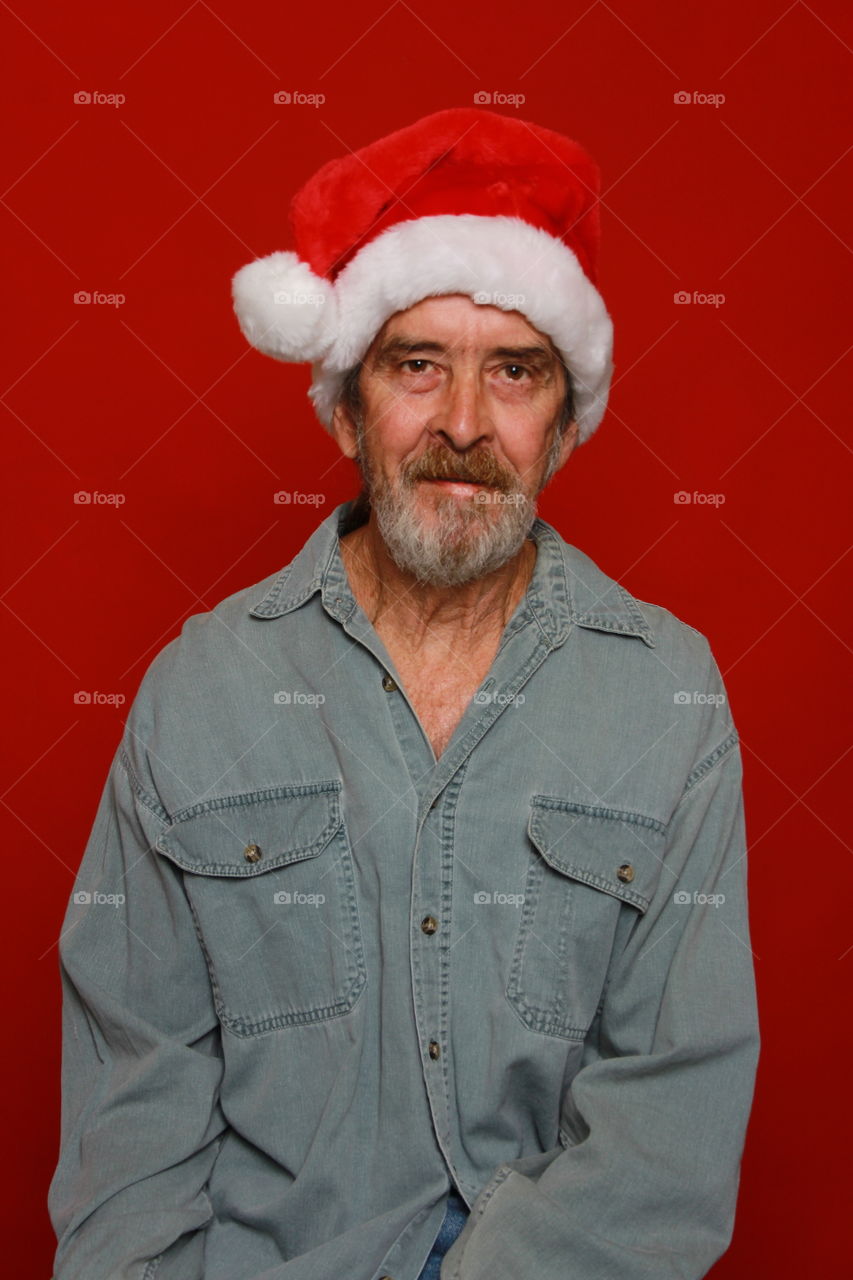 Senior man wearing santa claus hat