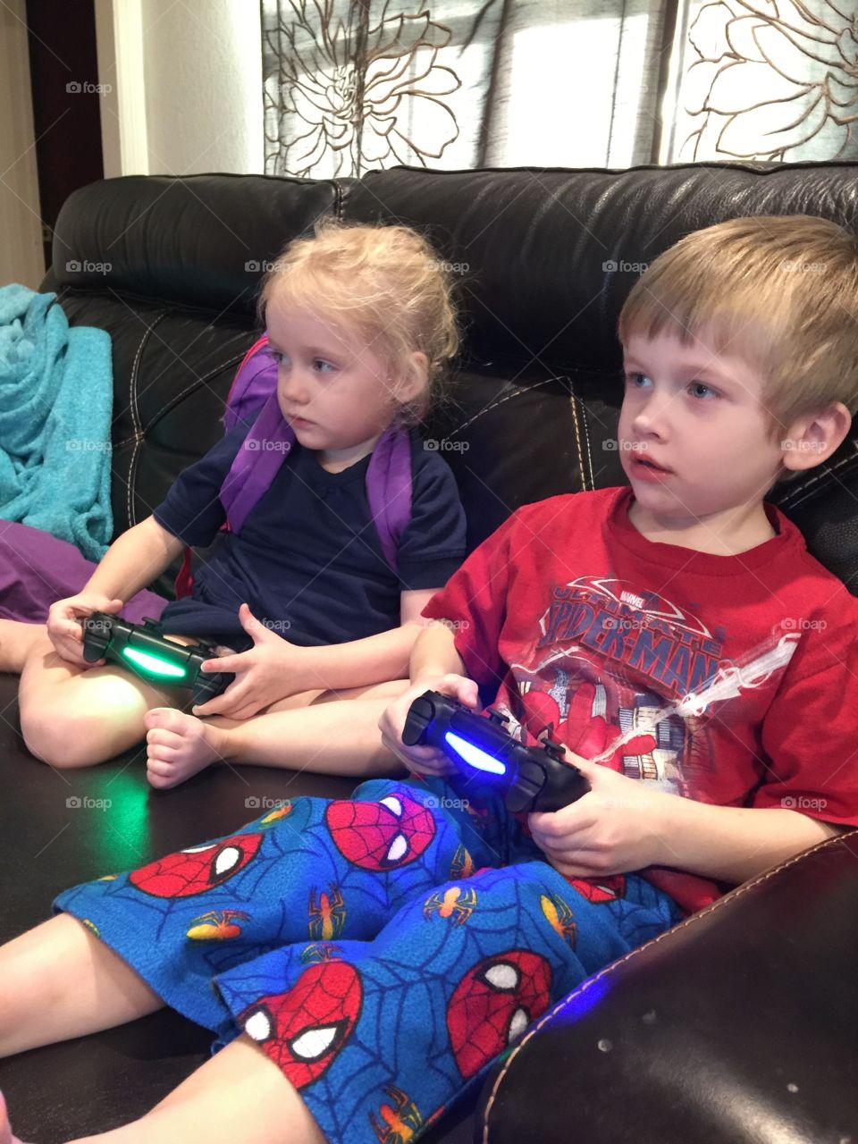 Boy, girl twins playing PlayStation 