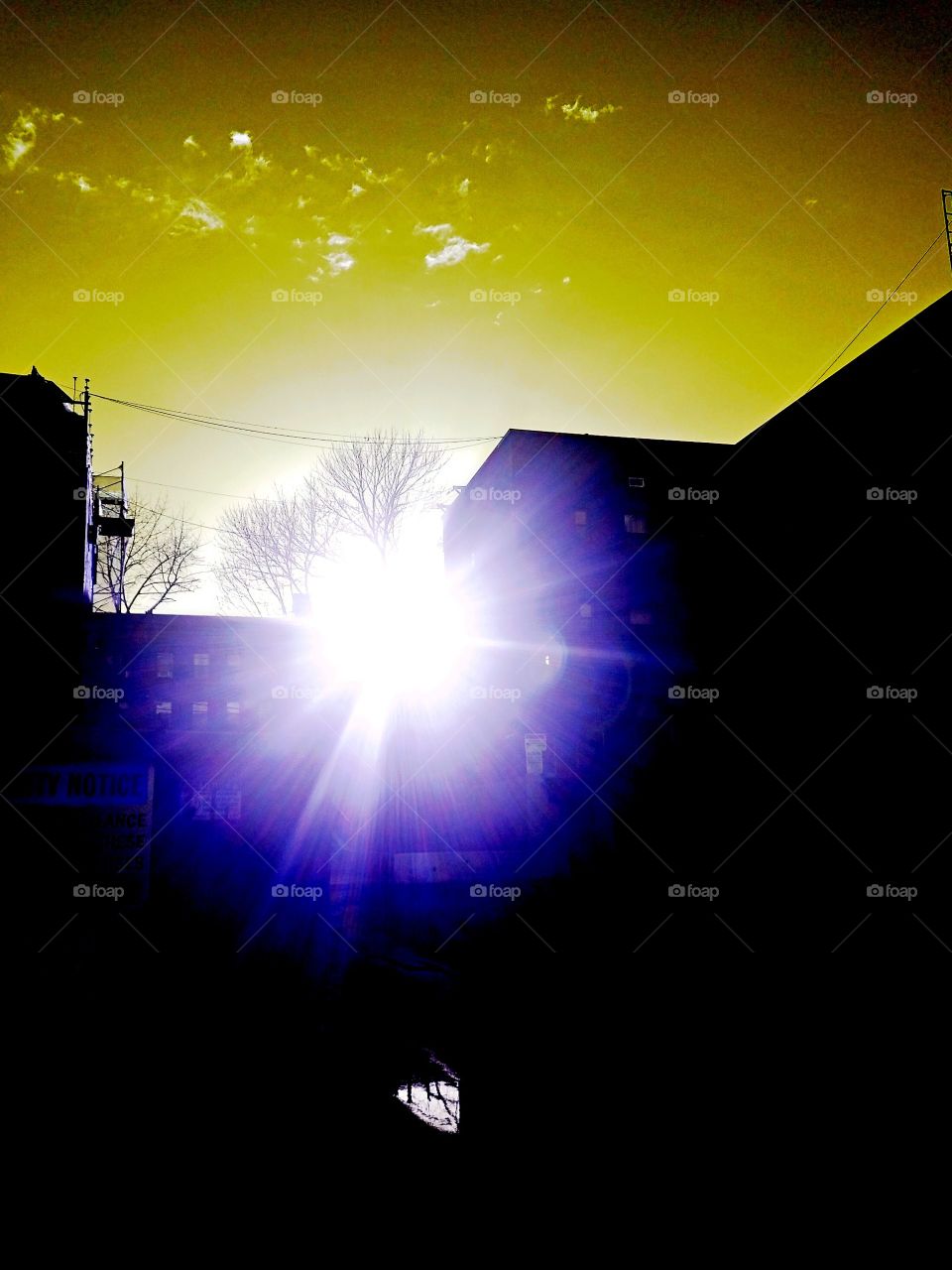 Sun glare peaking through the clouds after a rain storm in Bayside NY on a warm April evening