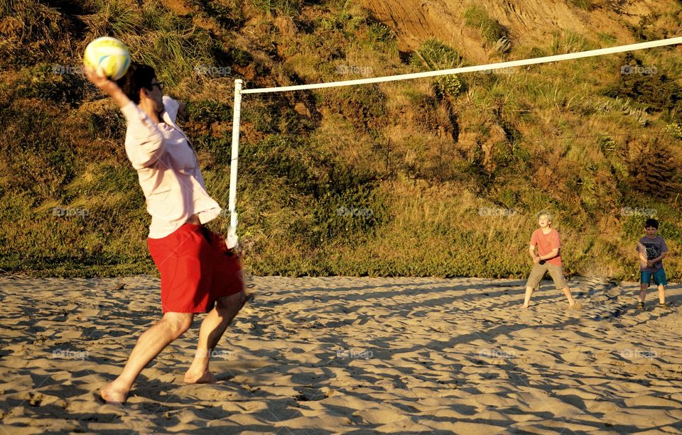 Family Playing Beach Volleyball
