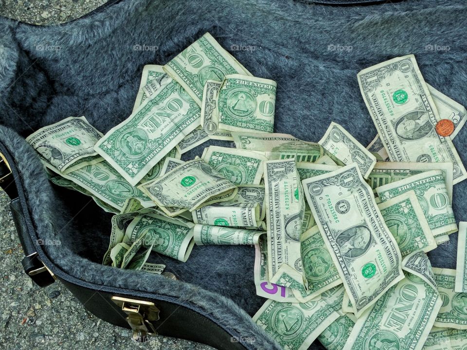 Dollar Bills In A Guitar Case
