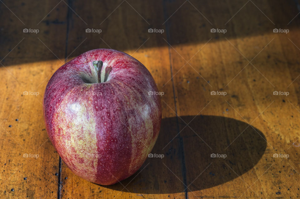Red apple on wooden table