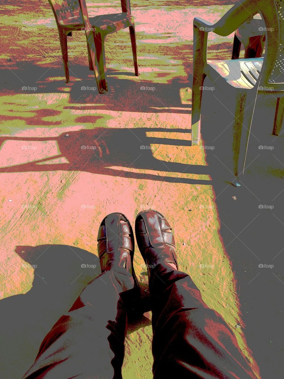 Low section of person's foot near plastic chairs