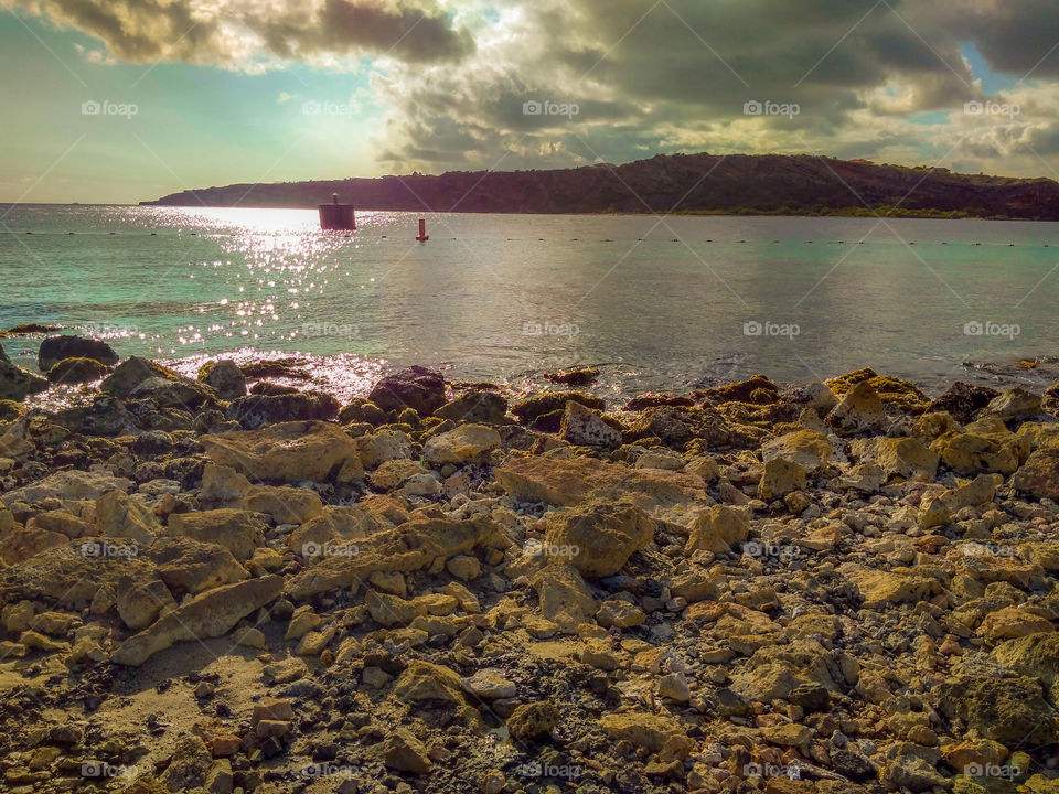 rocks at the beach with cloudy skies ⛅