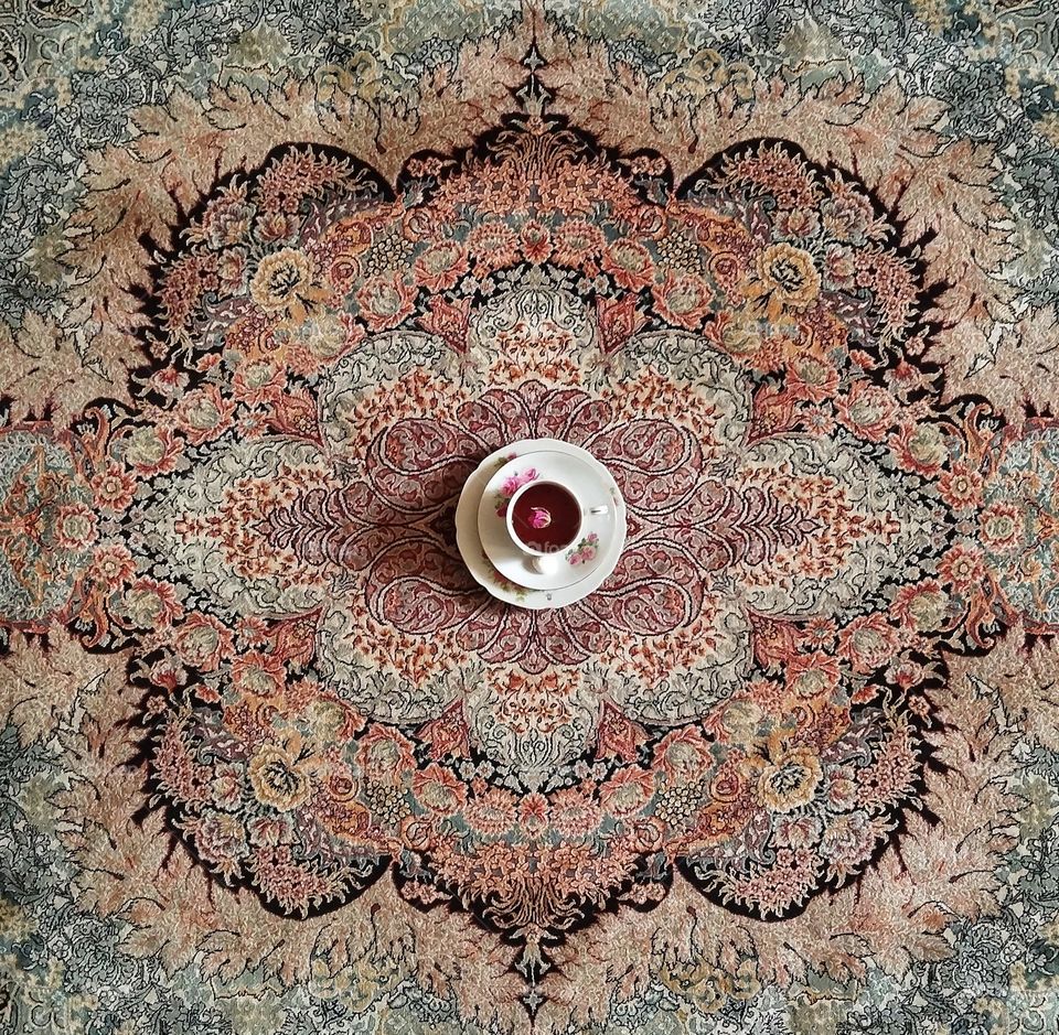 I value the carpet, even though it is placed under the feet, but its designs and patterns are a world of greatness. For this reason, I use it as a precious background  for exquisite works like this vintage porcelain rose tea cup from one century ago