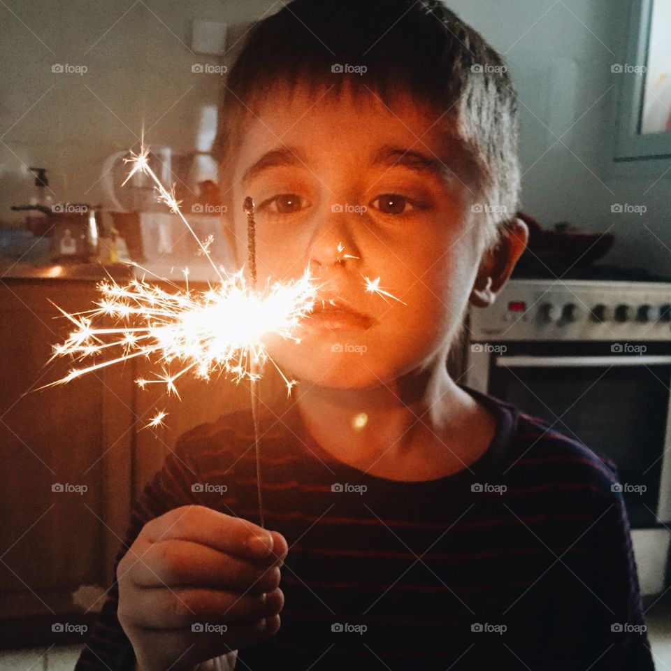 Boy holding sparkler