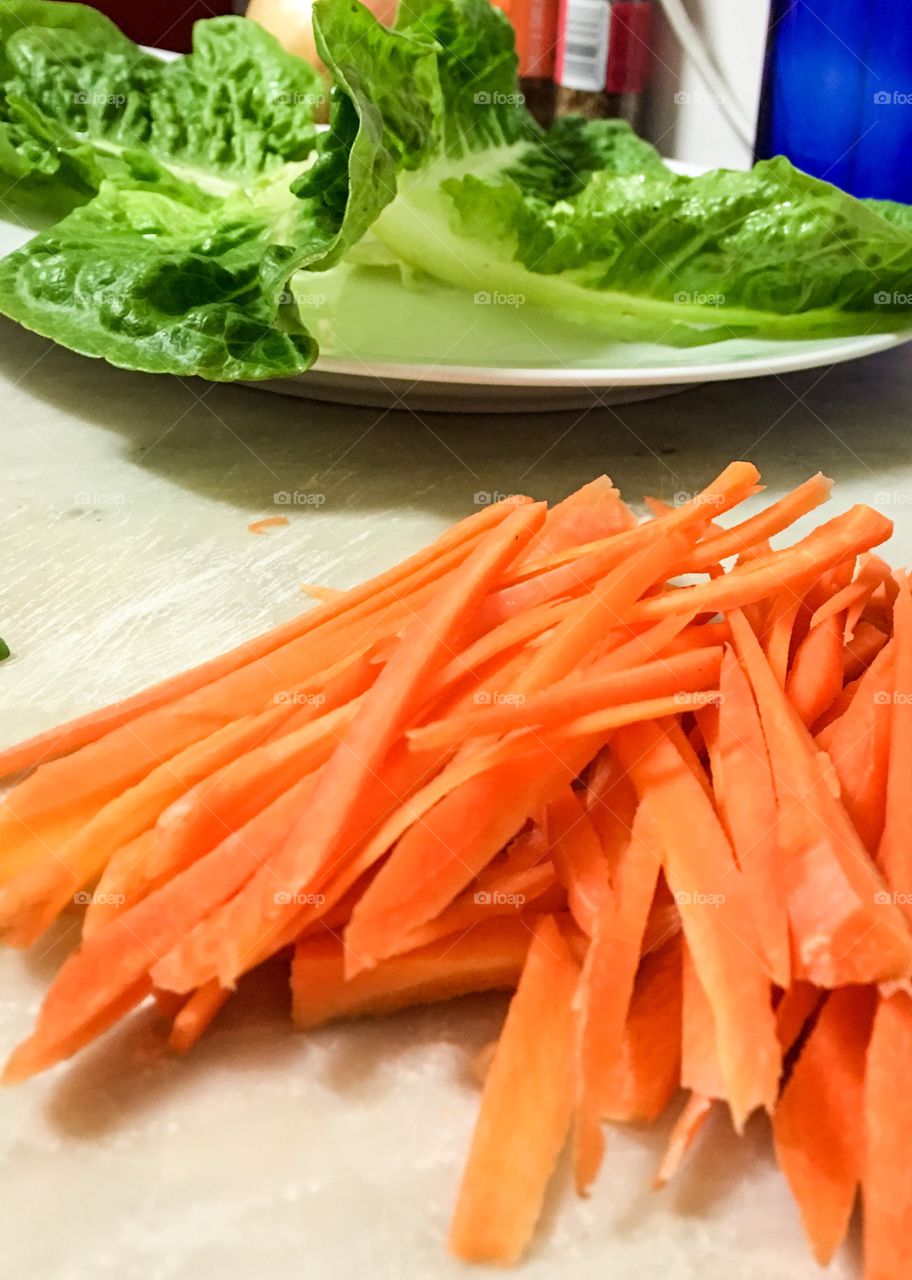 Orange carrot sticks food prep on counter 