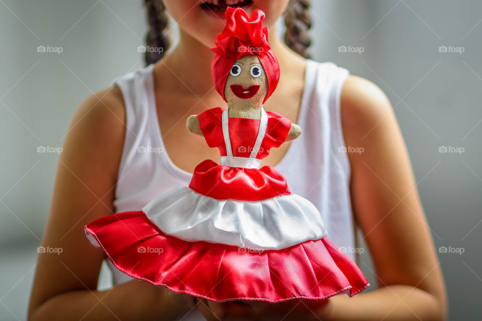 Handmade toy in the hands of a cute girl