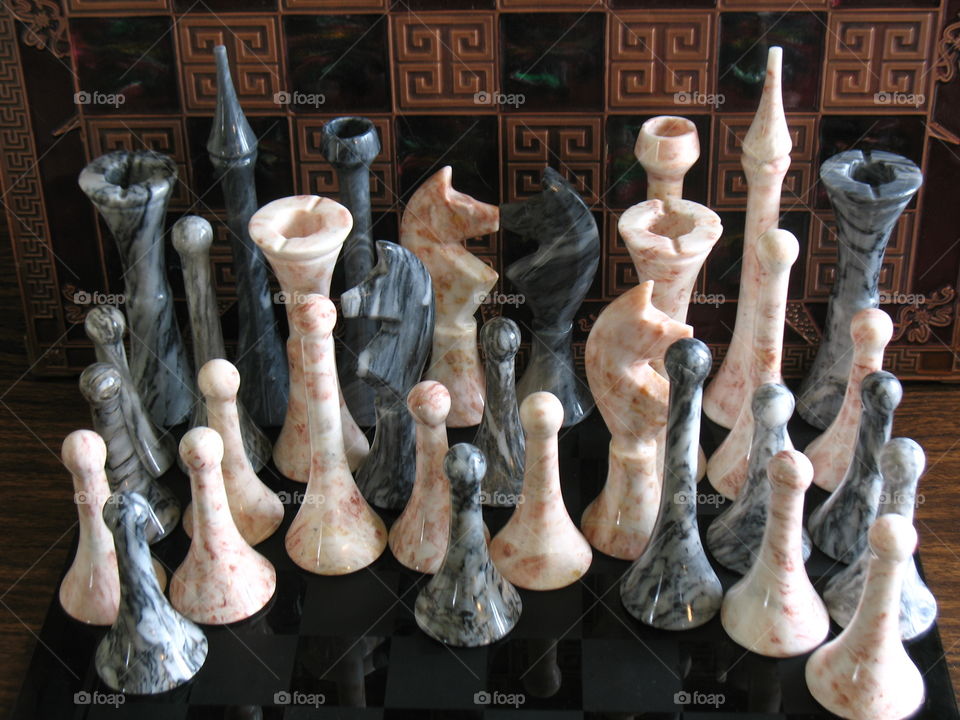 Your move. Granite chess pieces with ornate chess board