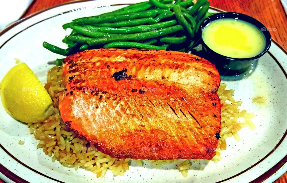 Dinner salmon fillet with rice garnish and green beans