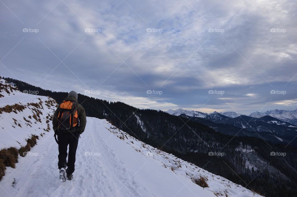 Photo of a young man hiking in the mountains 