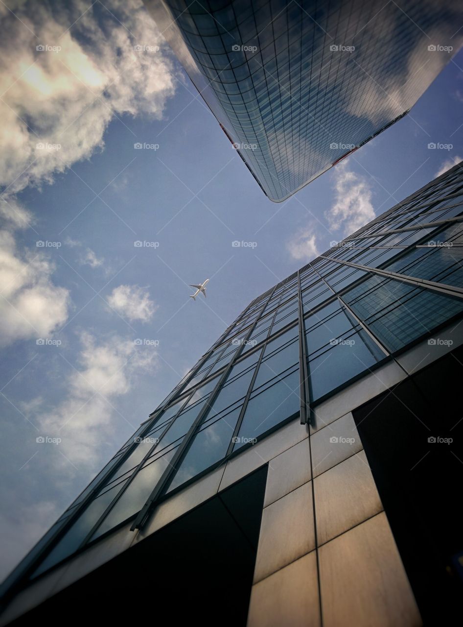 Airplane flying above building