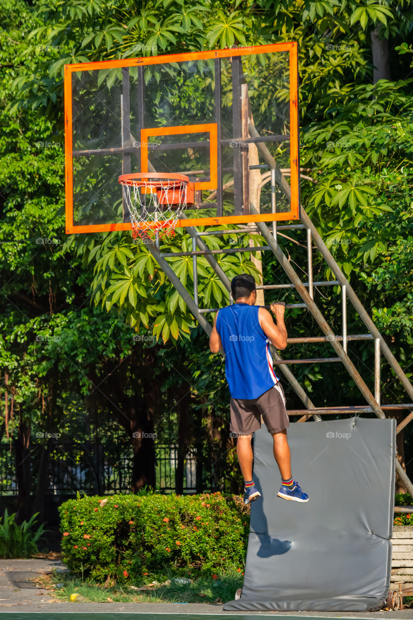 Asian man is warmed up before exercise in the park.