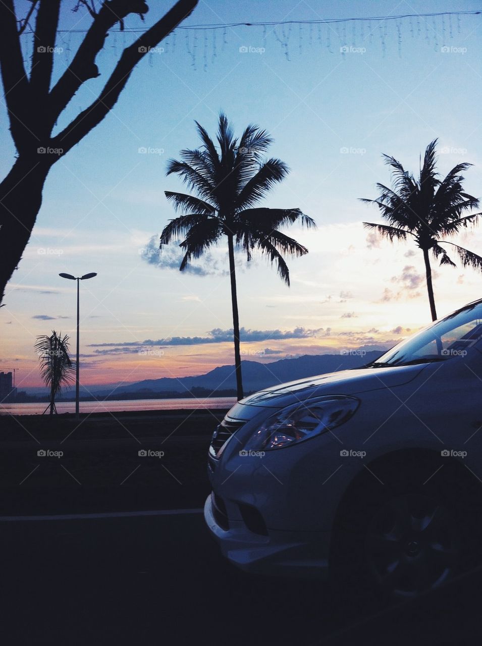 Close-up of car on road at sunset