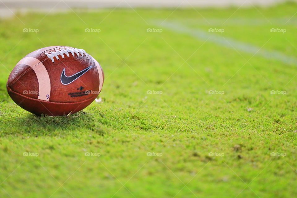 American Football. Got personal and close with an American football at the sidelines of a game. 