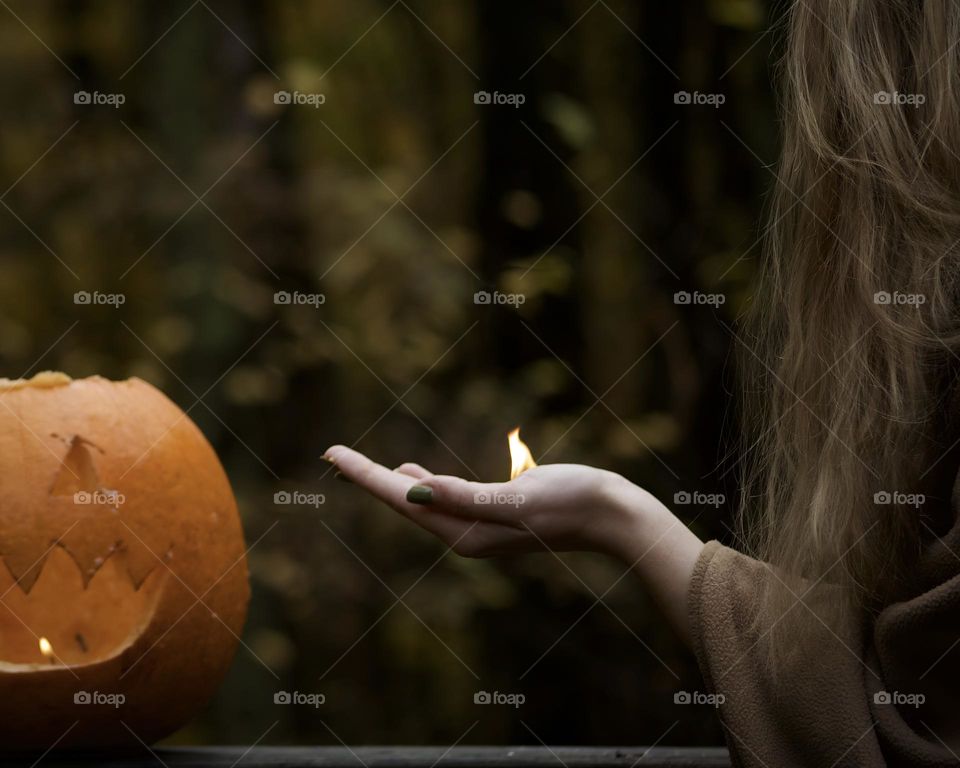 Holding a flame to Autumn pumpkin