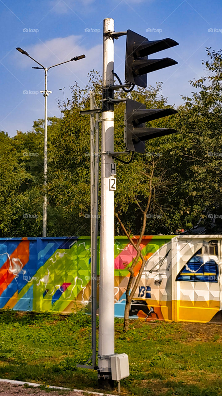 Railway semaphore, pillar, graffiti, fence, rails