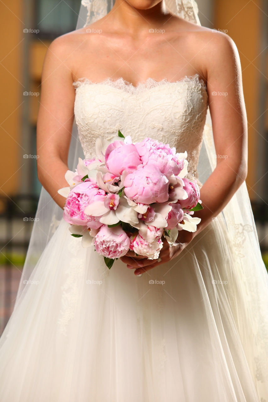 Peonia flowers and bridal dress