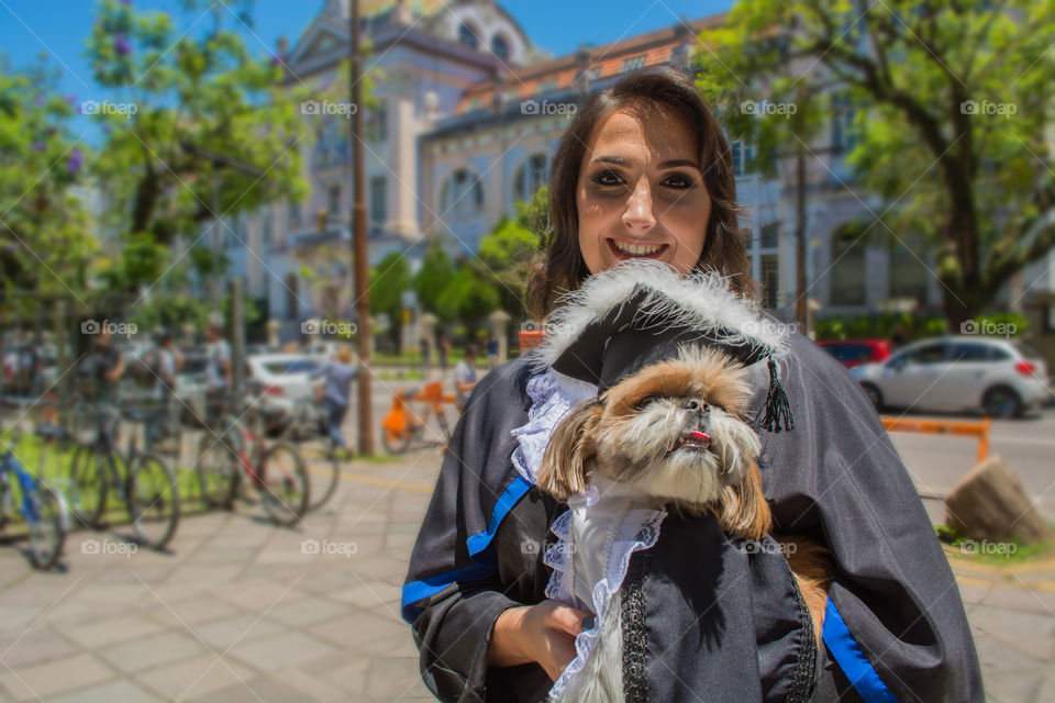 Happy girl graduating with her dog