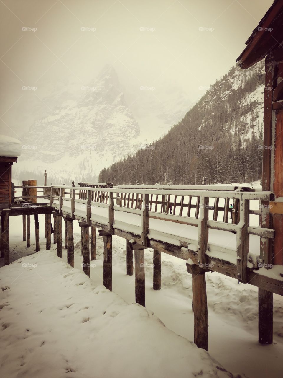 Wooden made piers covered by snow at