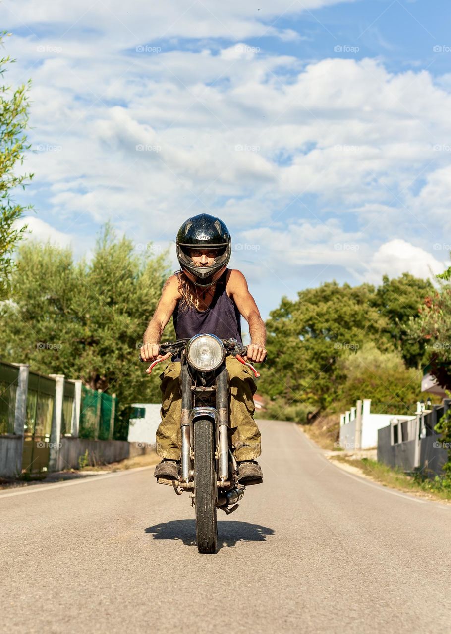 Man on motorbike driving on the road