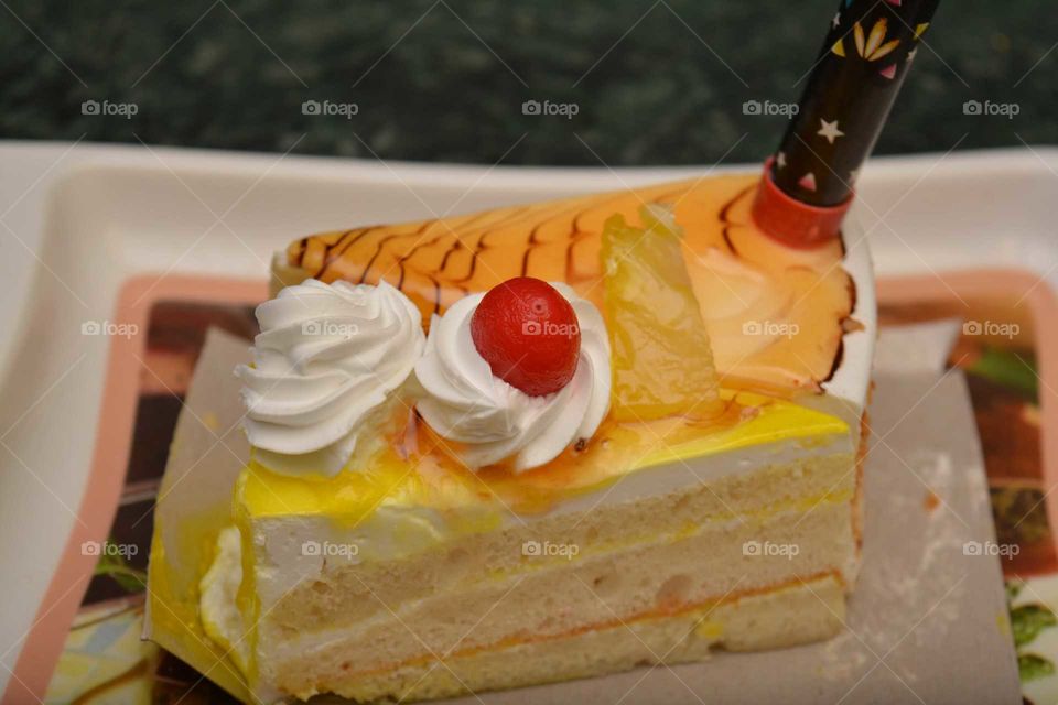 creamy pastery with cheery on top. yummy looking cake. food photography.