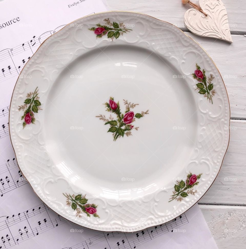 Retro porcelain plate with roses and reliefs