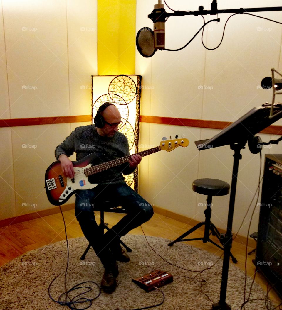 Bass player recording a track