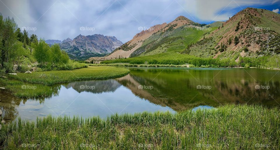 Panaramic view of high Sierra Mountain Lakes surrounded by beautiful green mountains 