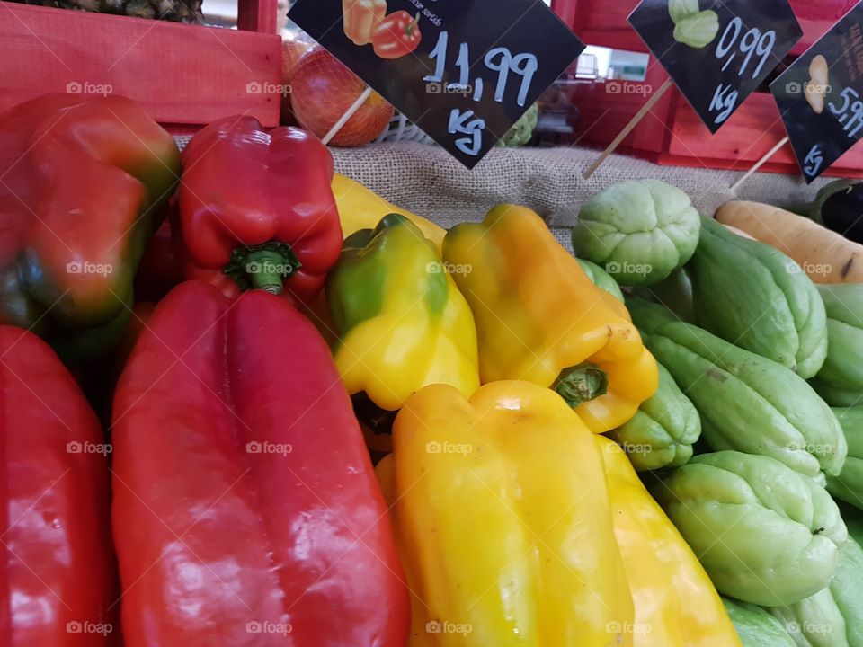 Fresh red and yellow peppers on the market