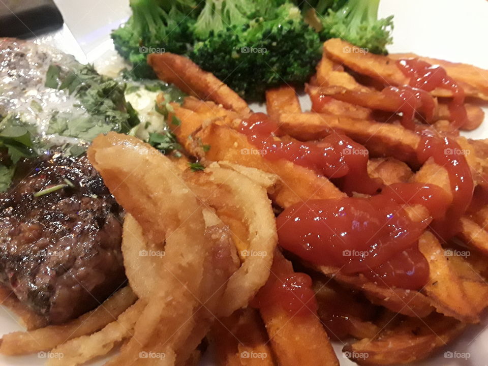 Steak with fries and broccoli