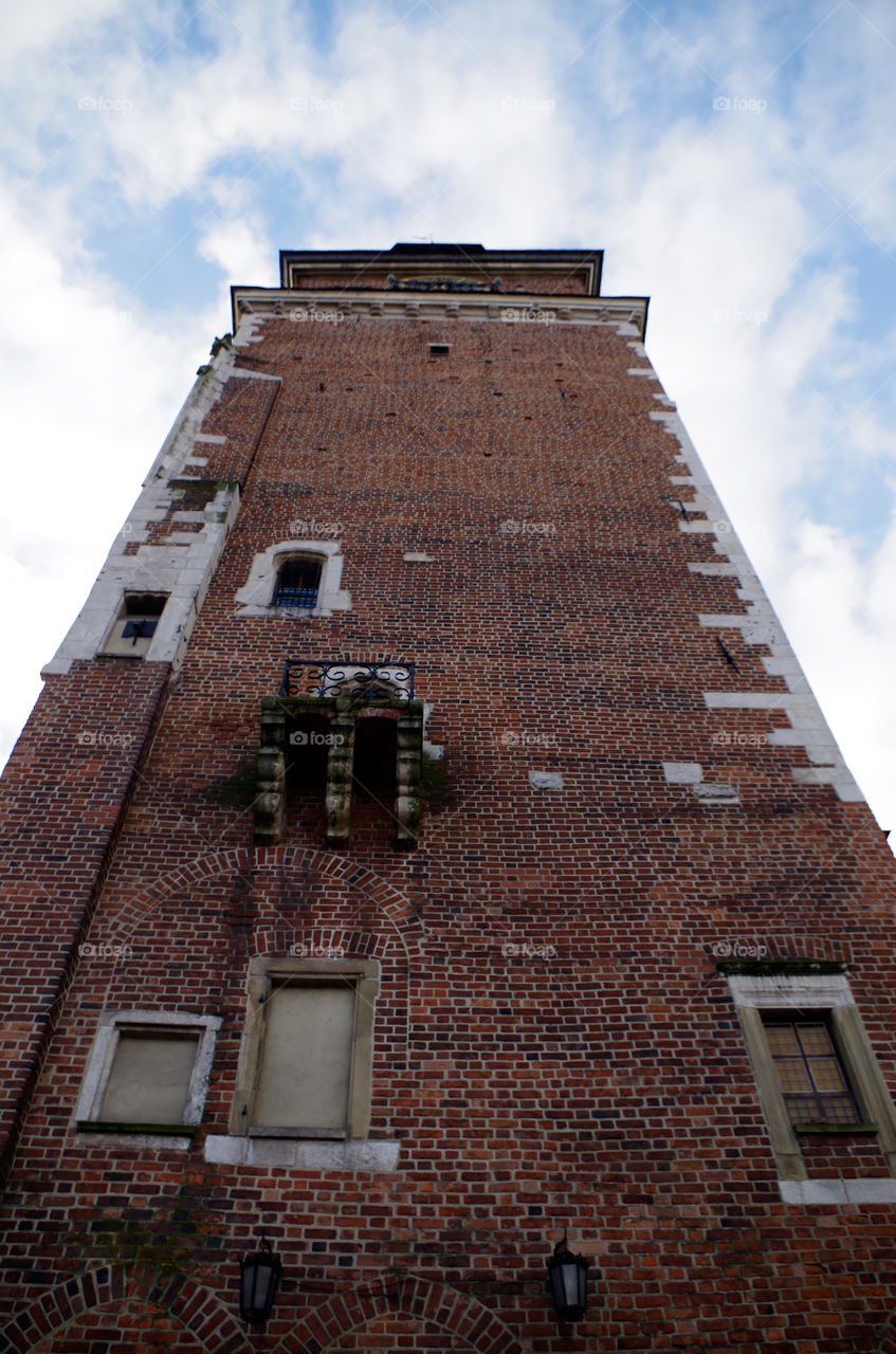 Low angle view of building exterior against sky in Kraków, Poland.