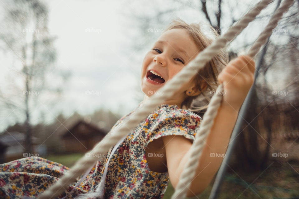 Little girl has fun on swing