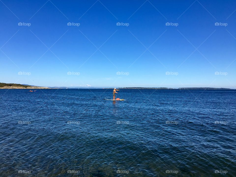 Blue Pacific, the paddler and Mt . Baker in a distance