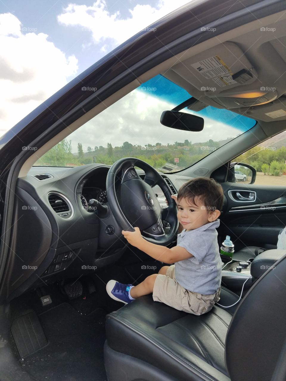 Portrait of a cute boy sitting in car