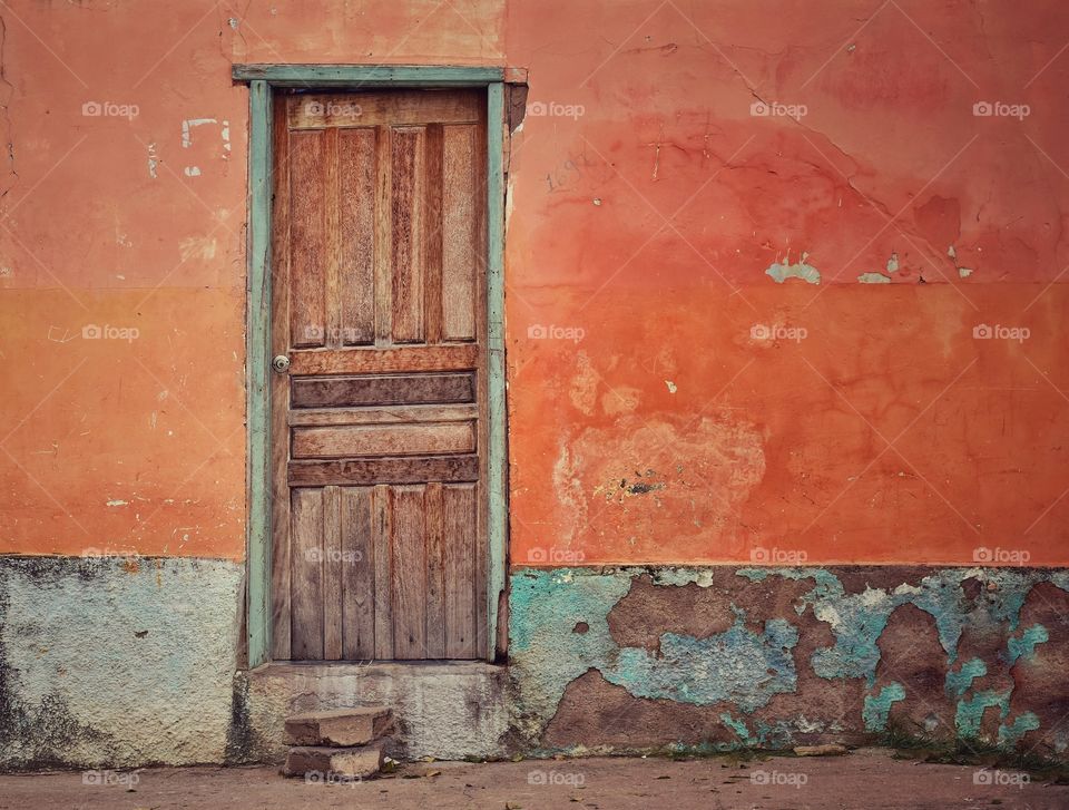 Orange color house and wooden door