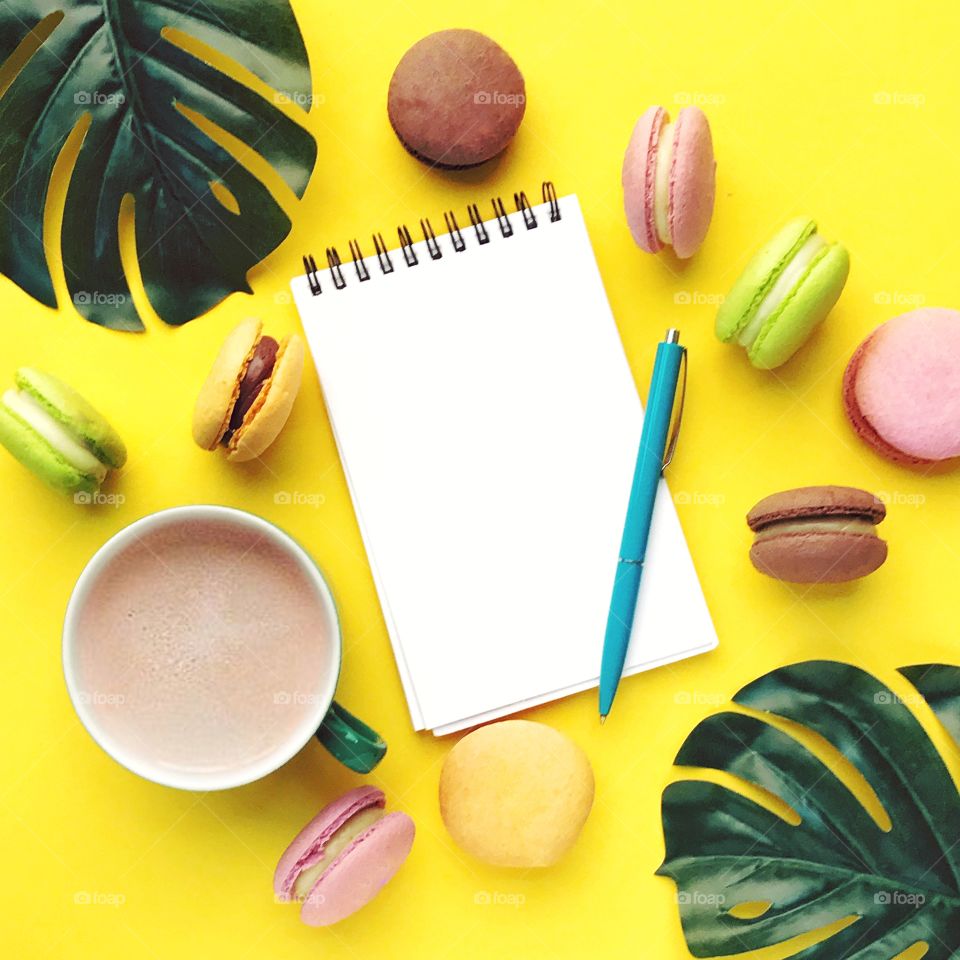 Tropical flat lay.Good morning with macaroons and coffee