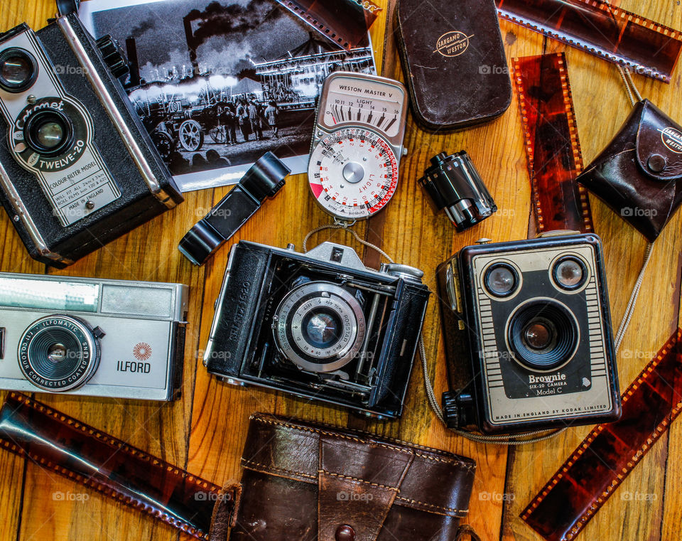 Flat lay featuring old style, film cameras and accessories 