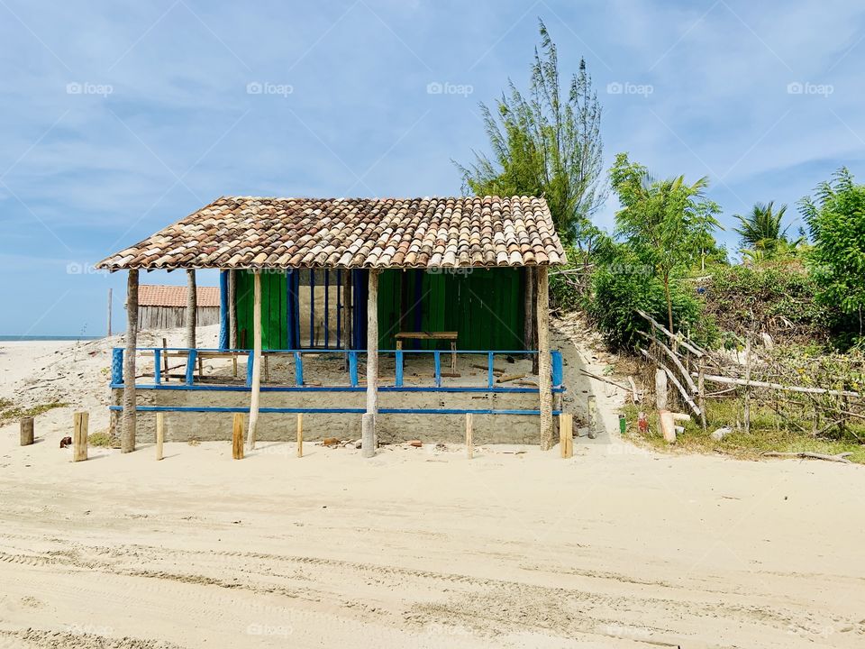 Blue and green wood house in the beach 