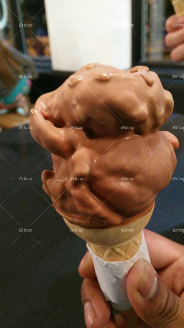 closeup of chocolate deeped ice-cream