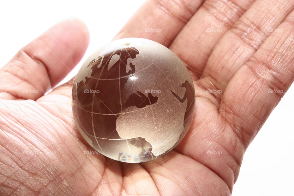 A glass globe in hand - depicting the business is spread all over the world